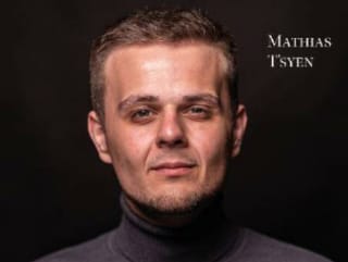 a man in a black turtle neck sweater.