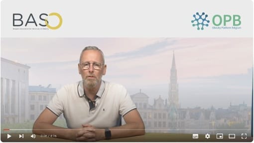 A person with glasses and a grey beard sits at a desk. The background shows a cityscape. Logos for BASO and OPB are present at the top of the image.