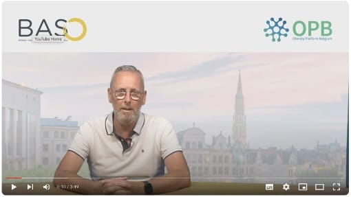 A man sits at a desk with logos for BASO (Belgium Association for the Study of Obesity) and OPB (Obesity Platform Belgium) visible at the top. A cityscape is seen in the background.