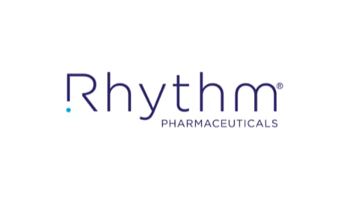 Rhythm Pharmaceuticals logo with company name in blue text on a white background. Rhythm Pharmaceuticals logo with company name in blue text on a white background.